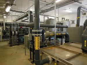 A water treatment system operates to remove volatile organic compounds from a contaminated underground water plume.