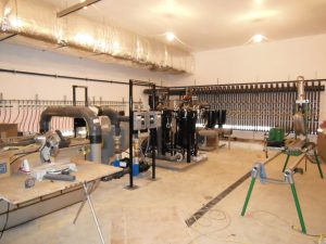 Bag filters, SVE blower, and piping headers during system construction of an industrial water treatment plant.
