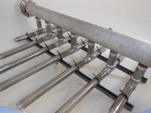 Stainless steel underdrain laterals designed for durable use with gravel subfill in an industrial sand filter system
